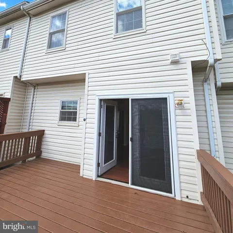 a view of a house with wooden deck