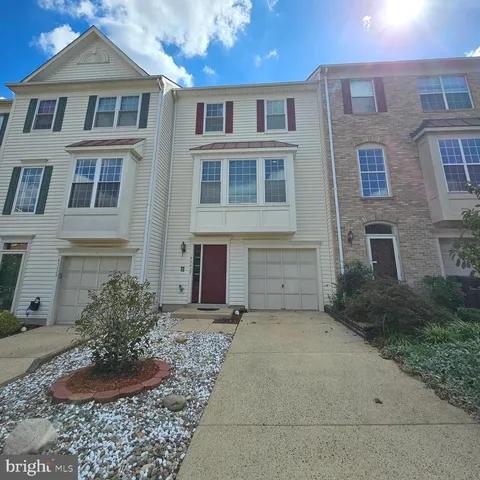a view of a brick house next to a yard