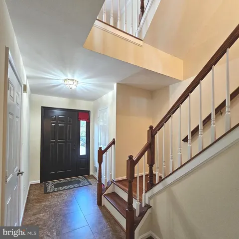 a view of staircase with wooden floor and a rug