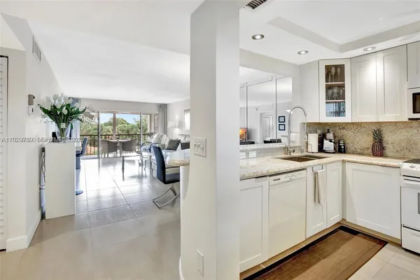 a large white kitchen with a large window