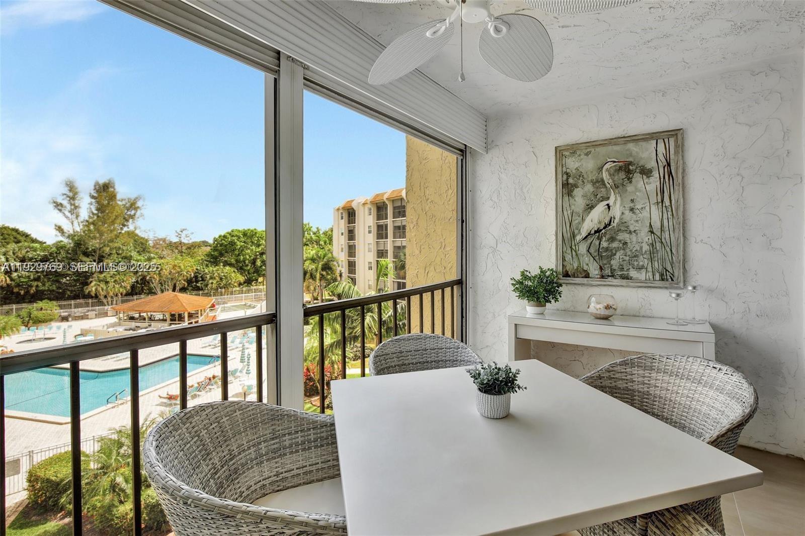 3930 Inverrary Boulevard, Unit 405D Lauderhill, FL 33319 - Photo 15 of 46 a dining room with large window and a table