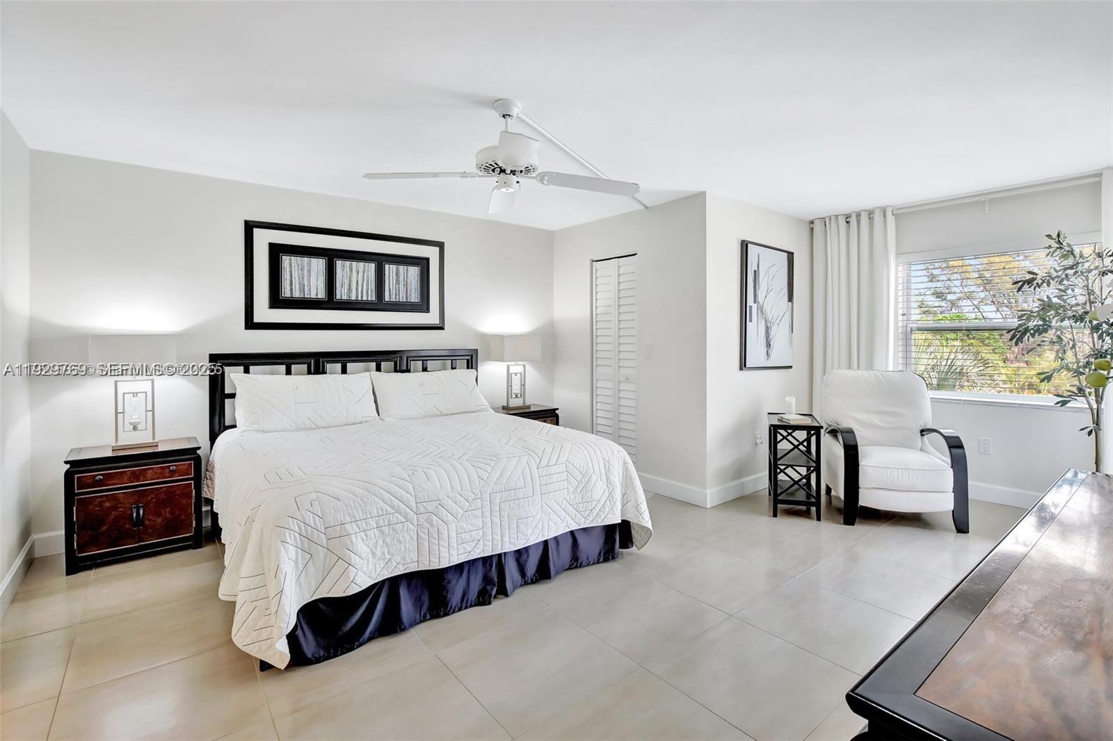 3930 Inverrary Boulevard, Unit 405D Lauderhill, FL 33319 - Photo 18 of 46 a bedroom with a bed and a couch