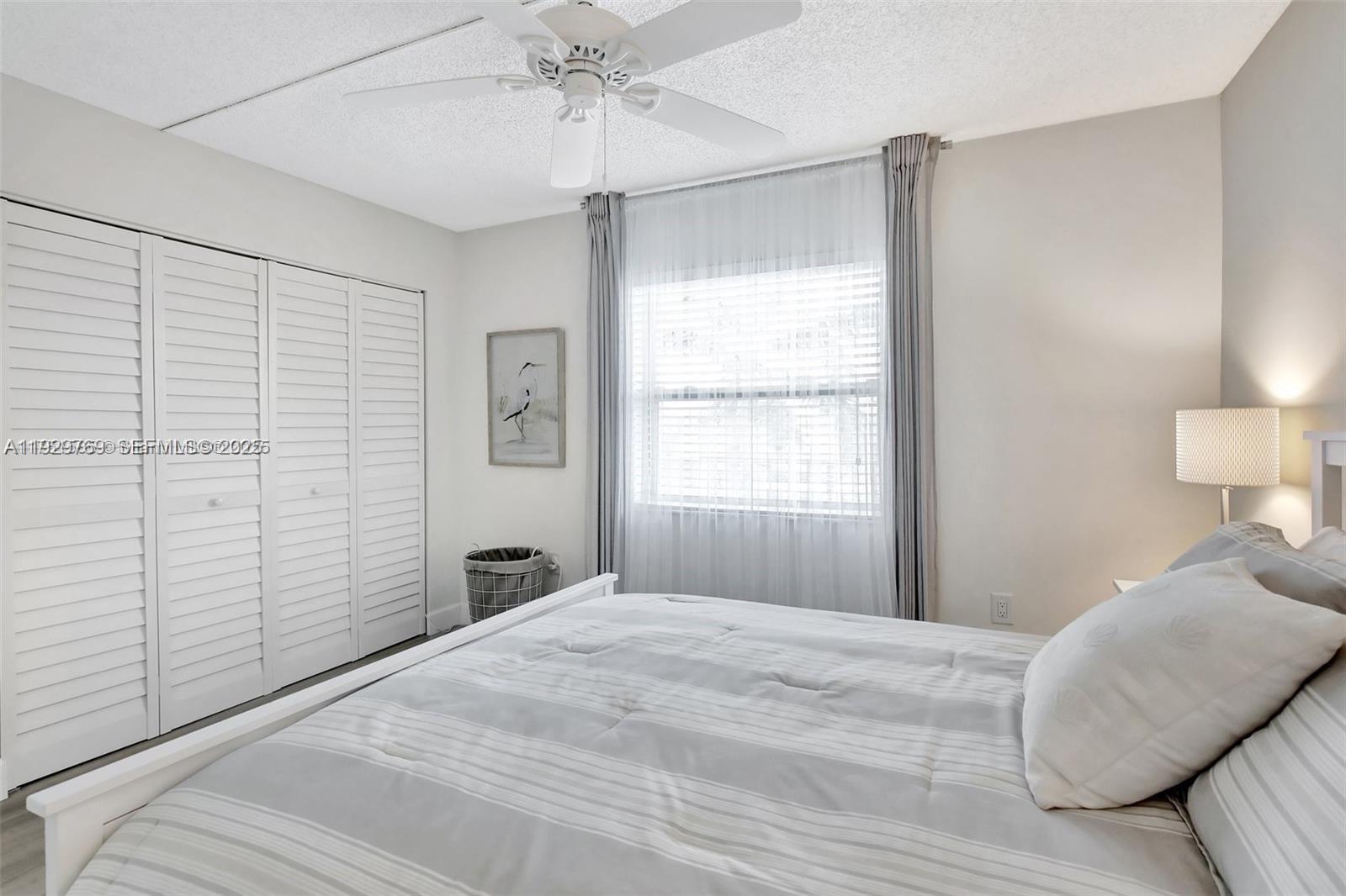 3930 Inverrary Boulevard, Unit 405D Lauderhill, FL 33319 - Photo 30 of 46 a bedroom with a bed and a window