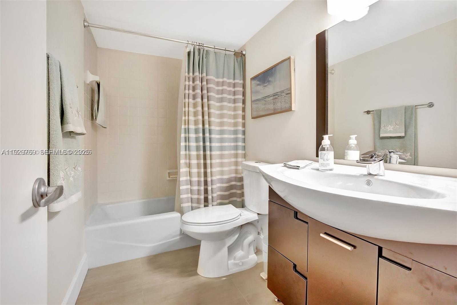 3930 Inverrary Boulevard, Unit 405D Lauderhill, FL 33319 - Photo 31 of 46 a bathroom with a sink toilet and shower