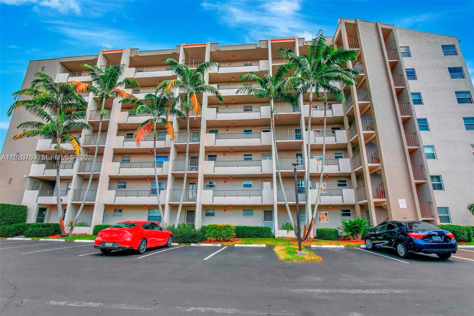 3930 Inverrary Boulevard, Unit 405D Lauderhill, FL 33319 - Photo 32 of 46 a front view of a building with street view and parking space