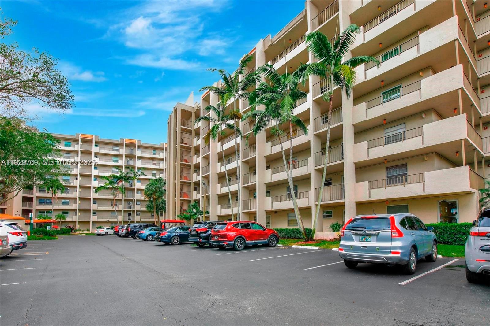 3930 Inverrary Boulevard, Unit 405D Lauderhill, FL 33319 - Photo 44 of 46 a car parked in front of a building