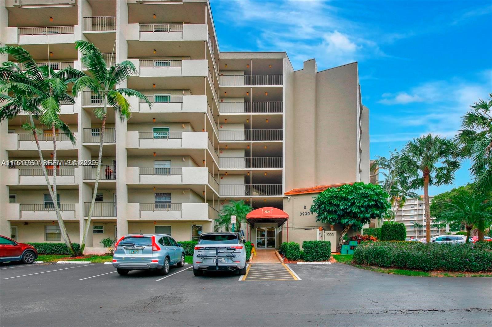 3930 Inverrary Boulevard, Unit 405D Lauderhill, FL 33319 - Photo 46 of 46 a car parked in front of a building with cars