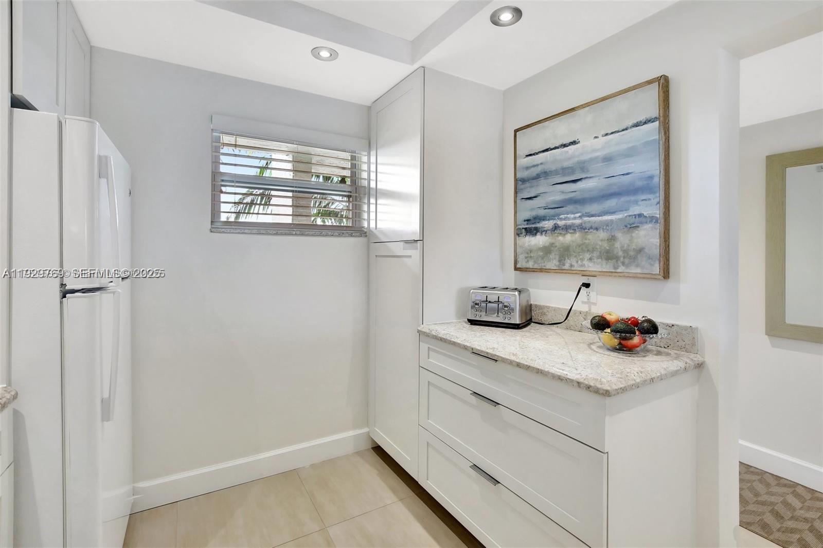 3930 Inverrary Boulevard, Unit 405D Lauderhill, FL 33319 - Photo 6 of 46 a bathroom with a granite countertop sink a window and a shower