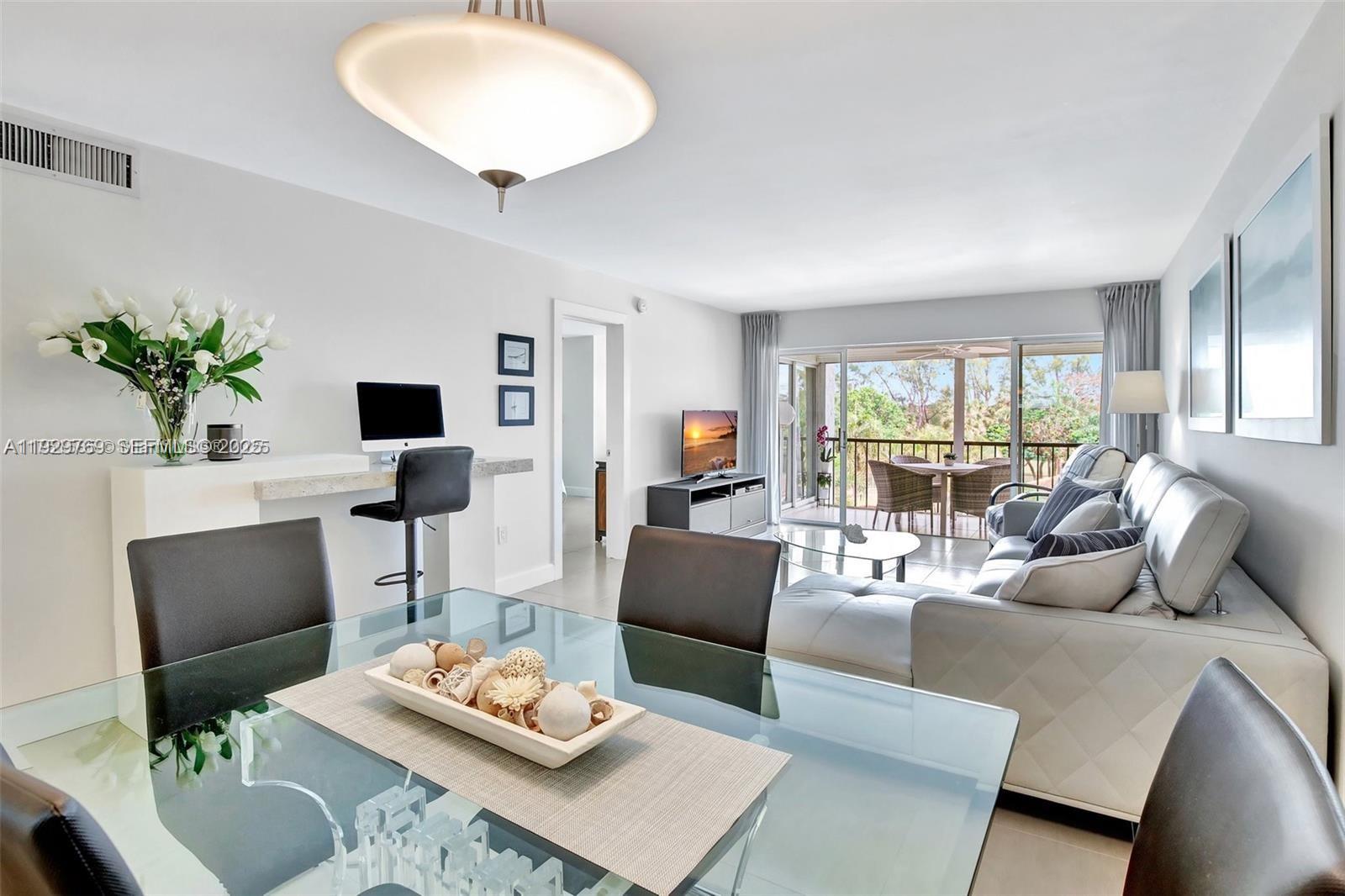 3930 Inverrary Boulevard, Unit 405D Lauderhill, FL 33319 - Photo 10 of 46 a living room with furniture and a large window