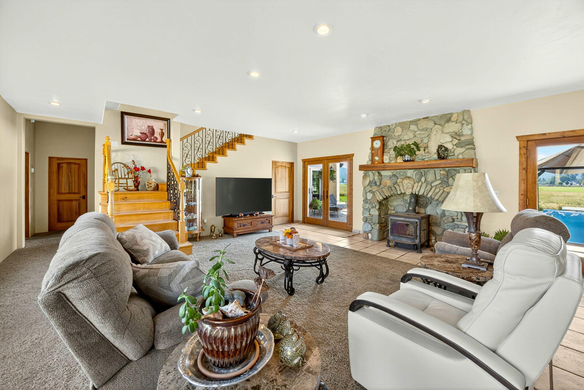 1176 Hamilton Road Jacksonville, OR 97530 - Photo 7 of 125 a living room with furniture a flat screen tv and a fireplace