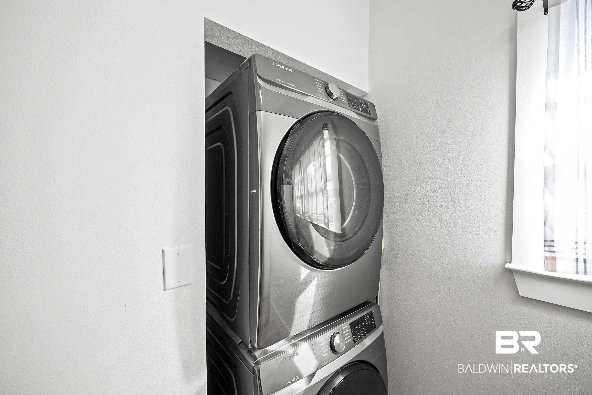 8490 Bay View Drive Foley, AL 36535 - Photo 57 of 67 Washroom featuring stacked washer / drying machine and a textured wall