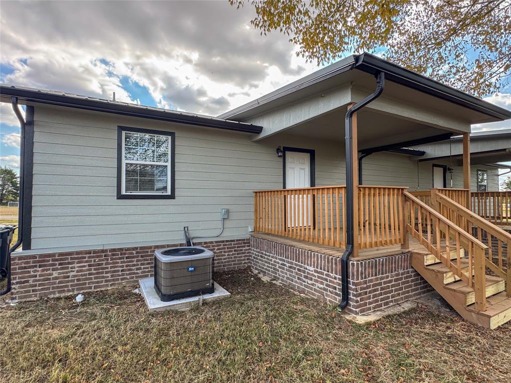 216 Smith Circle, Unit 1 Point, TX 75472 - Photo 14 of 15 a view of a house with a small yard and wooden fence