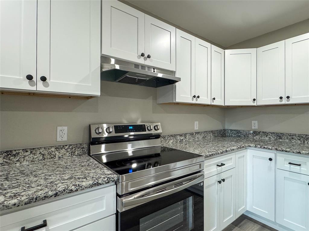 216 Smith Circle, Unit 1 Point, TX 75472 - Photo 2 of 15 a kitchen with granite countertop white cabinets and stainless steel appliances