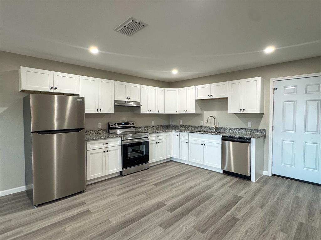 216 Smith Circle, Unit 1 Point, TX 75472 - Photo 6 of 15 a kitchen with a refrigerator stove top oven and sink