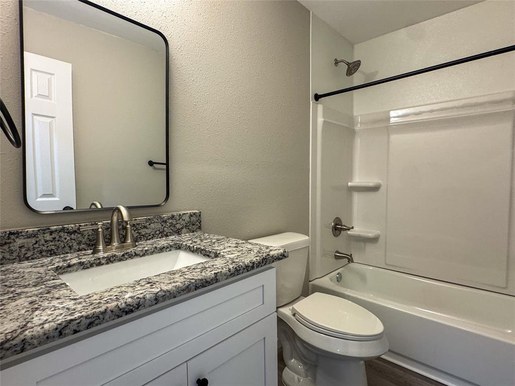 216 Smith Circle, Unit 1 Point, TX 75472 - Photo 10 of 15 a bathroom with a granite countertop sink toilet and shower