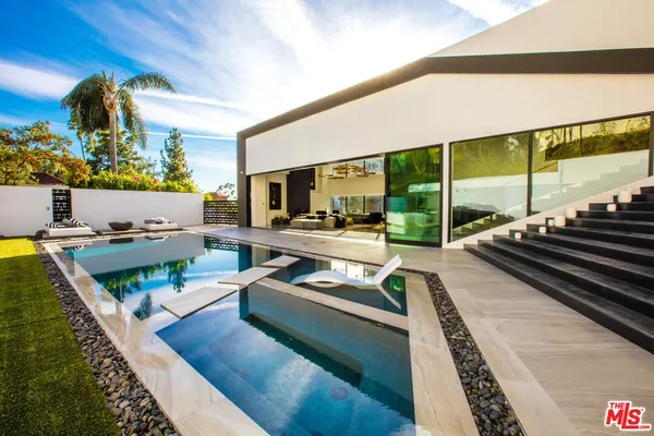 a view of swimming pool with seating area and furniture