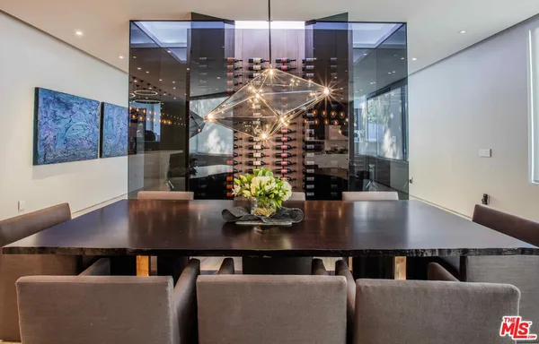 a view of a dining room with furniture and chandelier