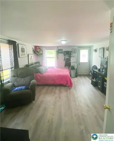 a bedroom with a bed and window