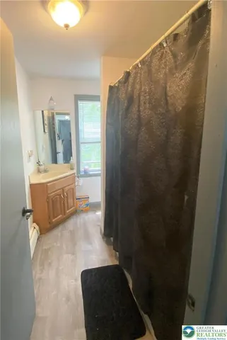 a bathroom with a sink a mirror and a shower