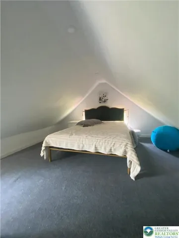 a bedroom with a bed and lamp