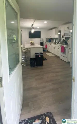 a kitchen with kitchen island a stove and a refrigerator