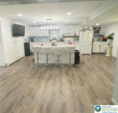 a kitchen with a refrigerator and a stove top oven