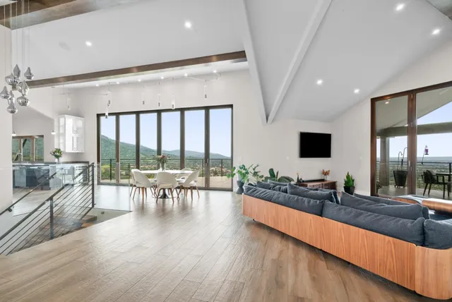 a living room with furniture and a floor to ceiling window