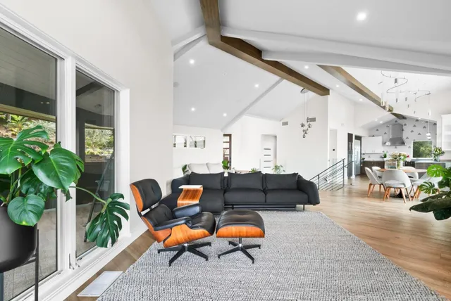 a dining room with furniture a chandelier and wooden floor