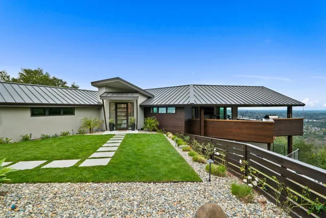 a front view of house with yard and green space