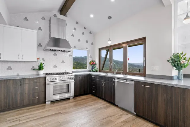 a large bed sitting in a bedroom next to a window