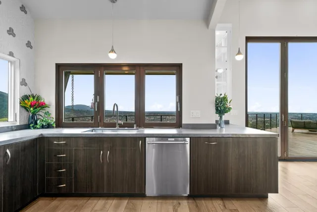 a view of cabinets a flat screen tv and a floor to ceiling window