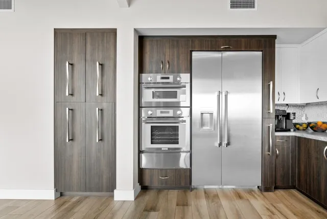 a large white bed sitting in a room next to a window
