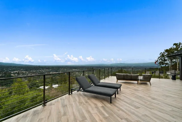 a living room with a large window and a flat screen tv