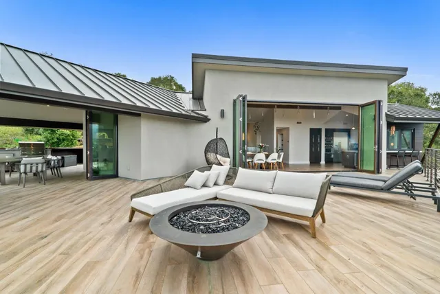 a backyard of a house with table and chairs