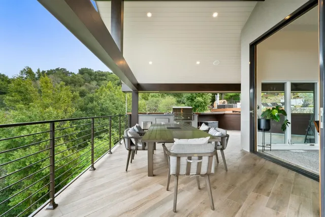 a view of a patio with table and chairs and potted plants