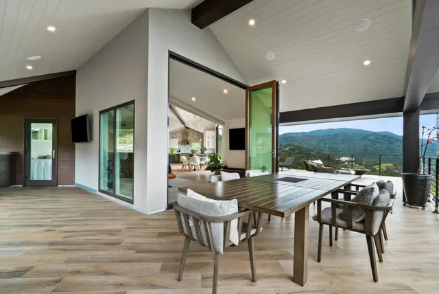 a view of balcony with floor to ceiling window and wooden floor