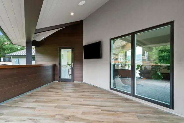 a balcony with trees in front of it
