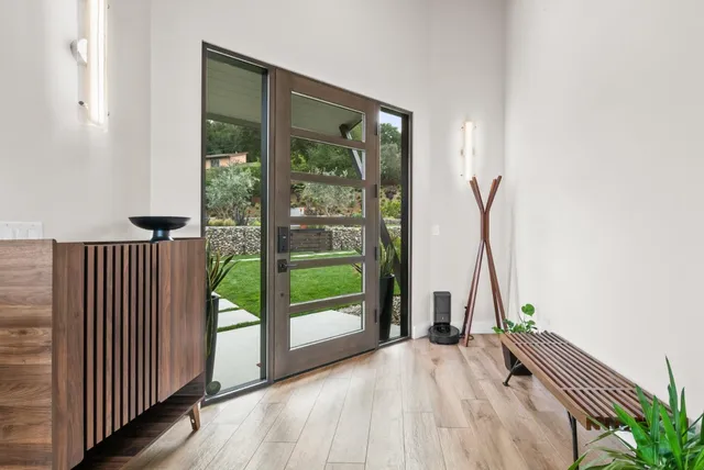 a living room with a couch and a potted plant