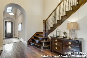 a view of entryway and hall with wooden floor