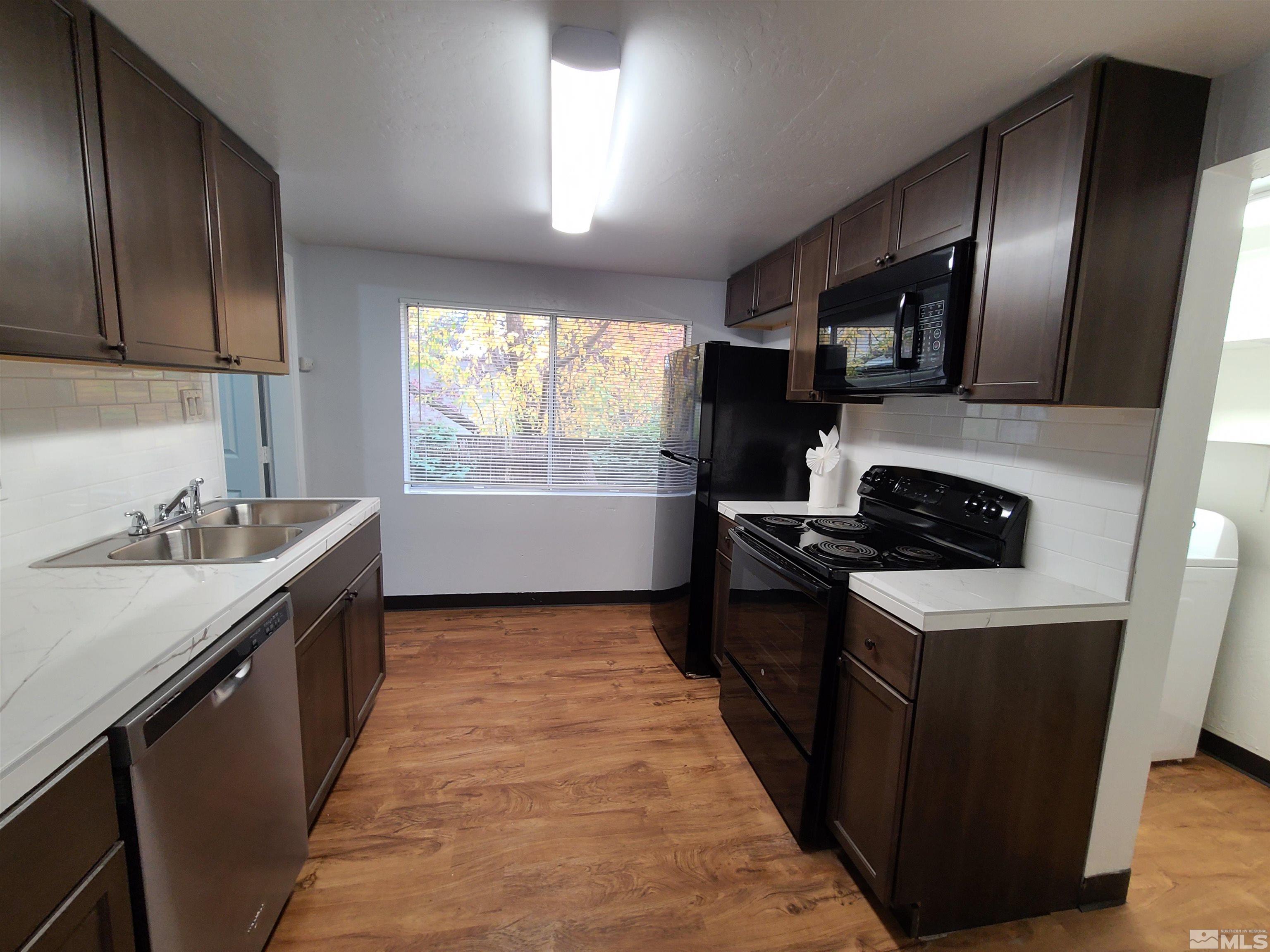 824-828 Locust Street Reno, NV 89502 - Photo 3 of 38 a kitchen with granite countertop stainless steel appliances a sink stove top oven and cabinets