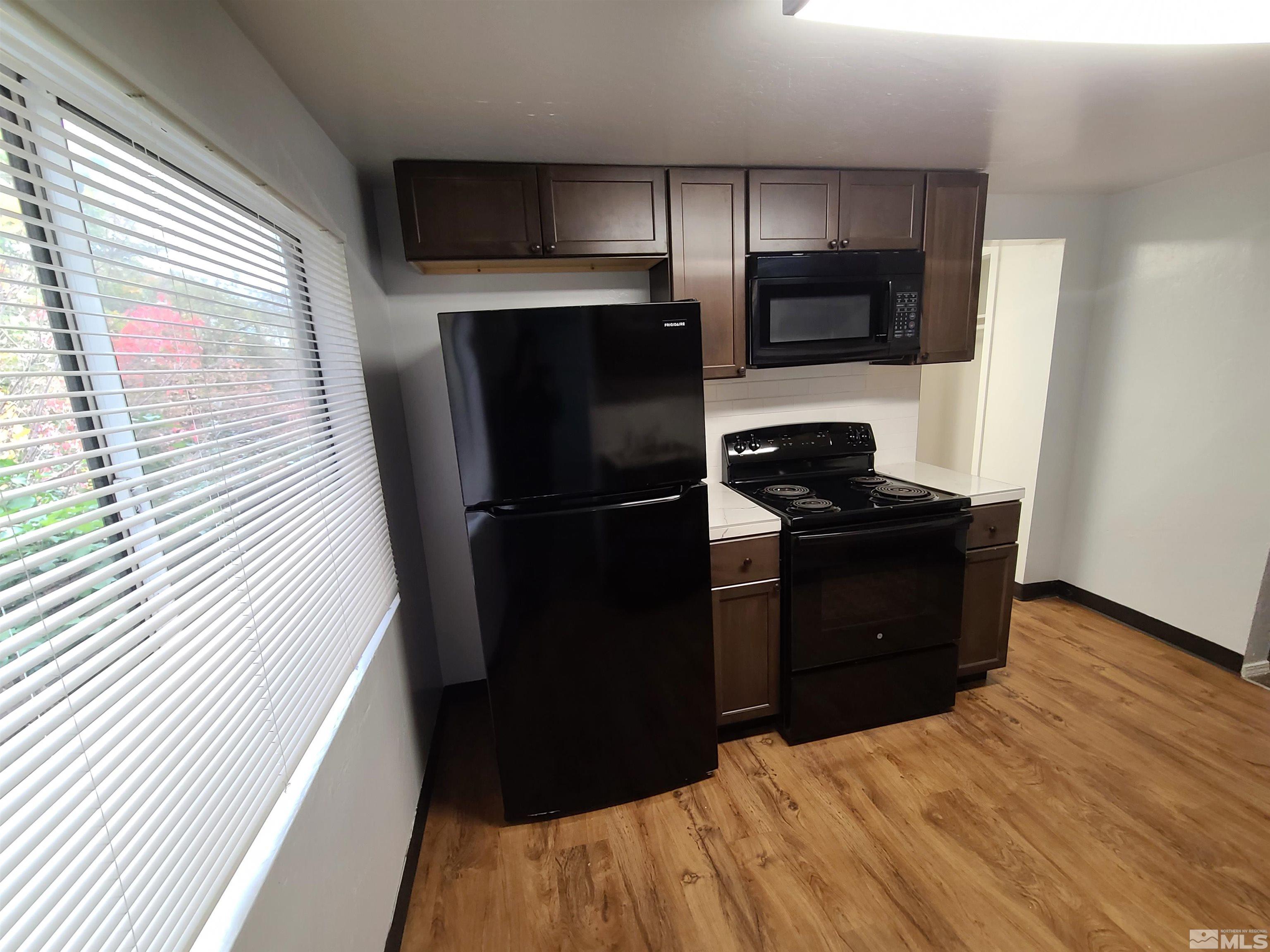 824-828 Locust Street Reno, NV 89502 - Photo 5 of 38 a kitchen with a refrigerator and a sink