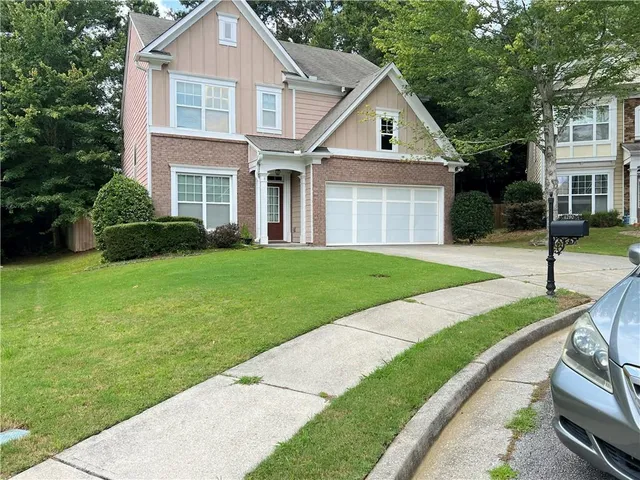 a front view of a house with a yard