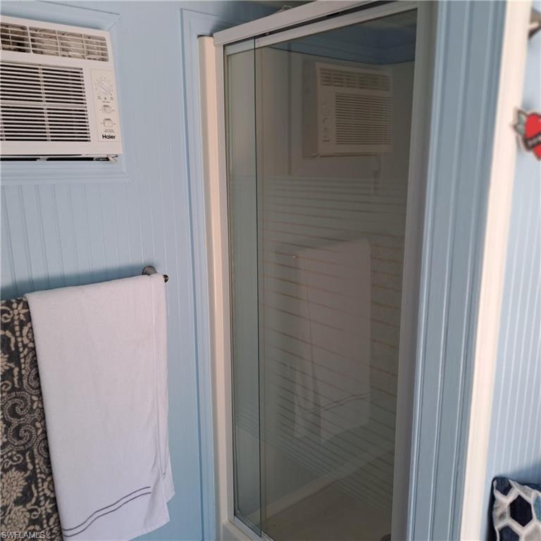 4914 Coach Lane Naples, FL 34114 - Photo 12 of 12 Bathroom featuring a stall shower and a wall mounted AC
