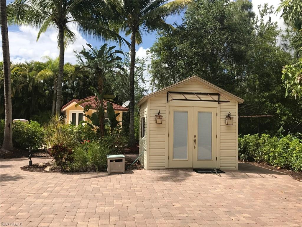 4914 Coach Lane Naples, FL 34114 - Photo 3 of 12 View of outdoor structure featuring view of wooded area