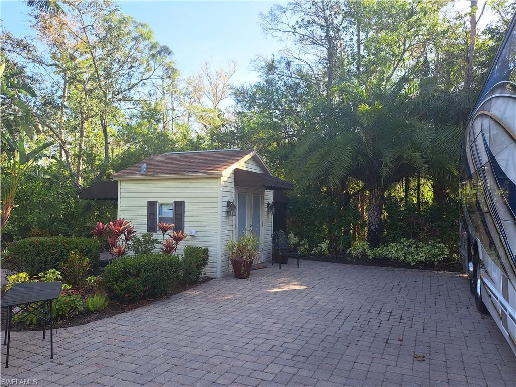 4914 Coach Lane Naples, FL 34114 - Photo 6 of 12 View of patio / terrace with an outbuilding