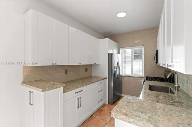 a kitchen with a sink stove and refrigerator