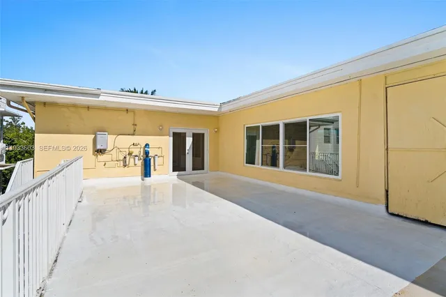a view of a patio with table and chairs potted plants with wooden floor