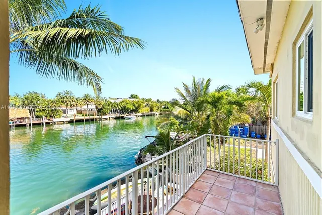 a view of a lake with a patio table and chairs