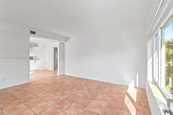 a view of an empty room and a window