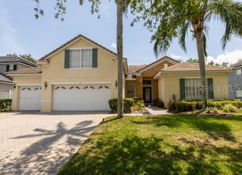 65 Calliope Street Ocoee, FL 34761 - Photo 1 of 60 a front view of a house with a yard and garage